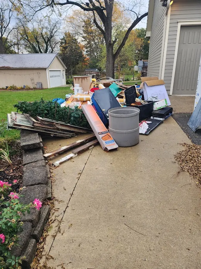 Dumpster being loaded with debris for Estate Cleanout Dumpster Rental in Floris